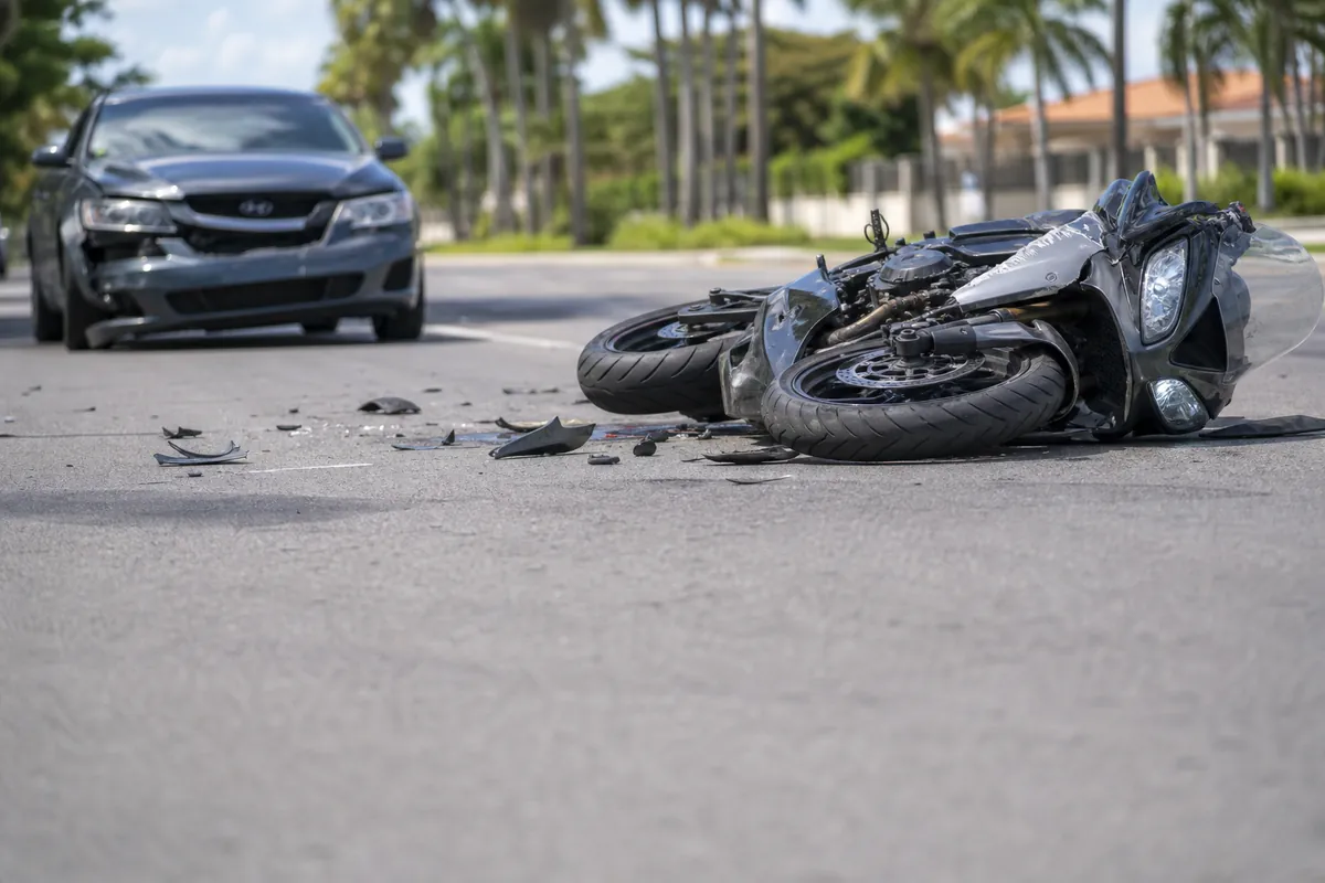 Motorcycle down on a road after a collision